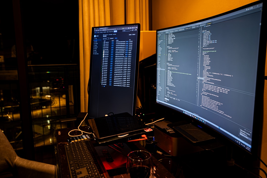 HTML5 code on monitor - A man sitting in front of a computer monitor