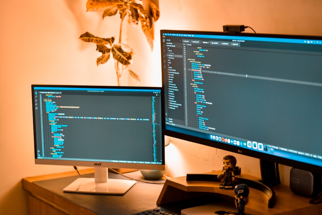 HTML5 code on monitor - coding screen with 2 monitors